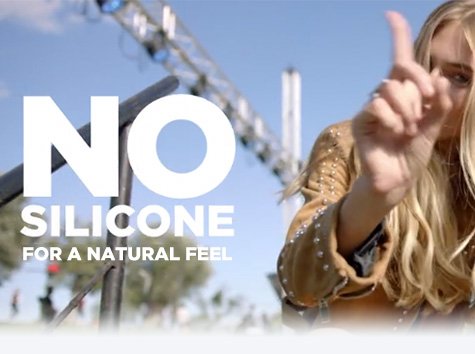 model holding up index finger shaking no to silicones